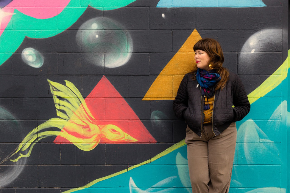 image of Maggie Ramirez in front of colorful wall
