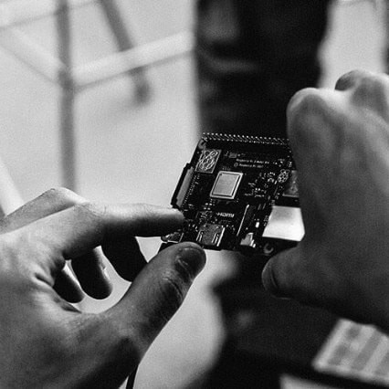 Hands holding a circuit board