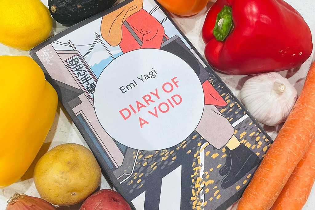 The book "Diary of a Void" by Emi Yagi among a variety of colourful vegetables