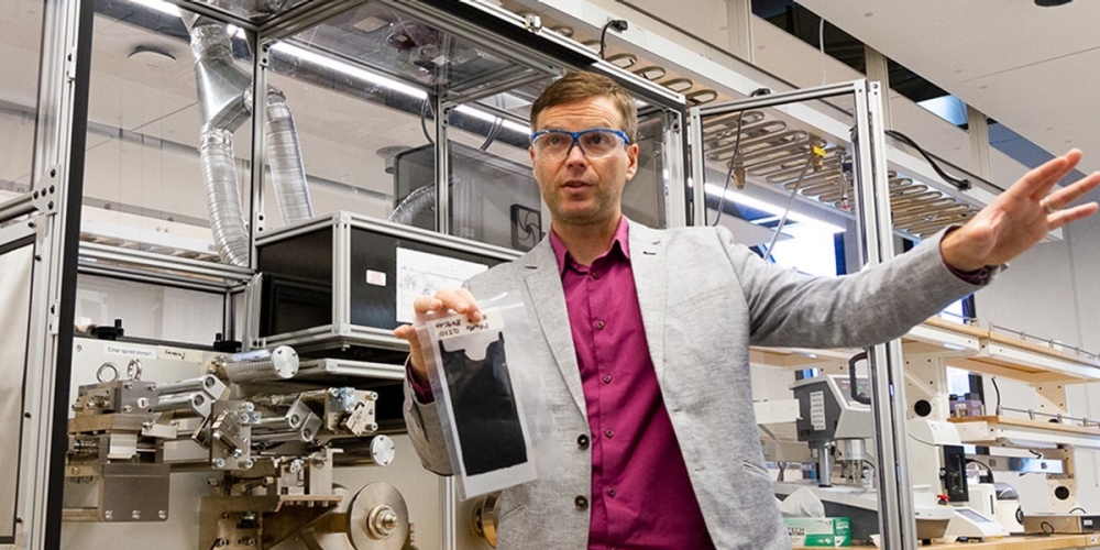 Simon Fraser University mechatronic systems engineering professor Erik Kjeang with a sample of a catalyst layer used in fuel cells.
