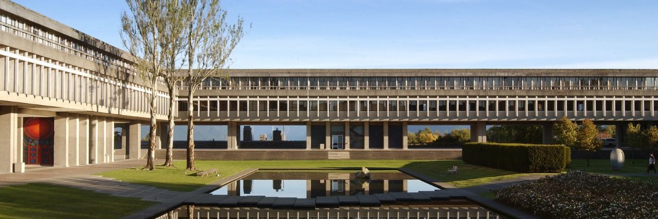 Simon Fraser University courtyard with reflecting pool and concrete buildings