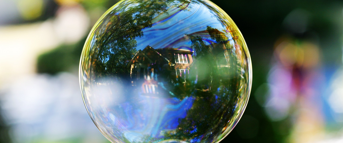 A water bubble reflecting a house