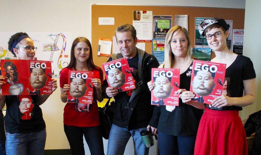 Five MPUB students holding up their magazine projects, a magazine tited EGO with a bright red cover. 