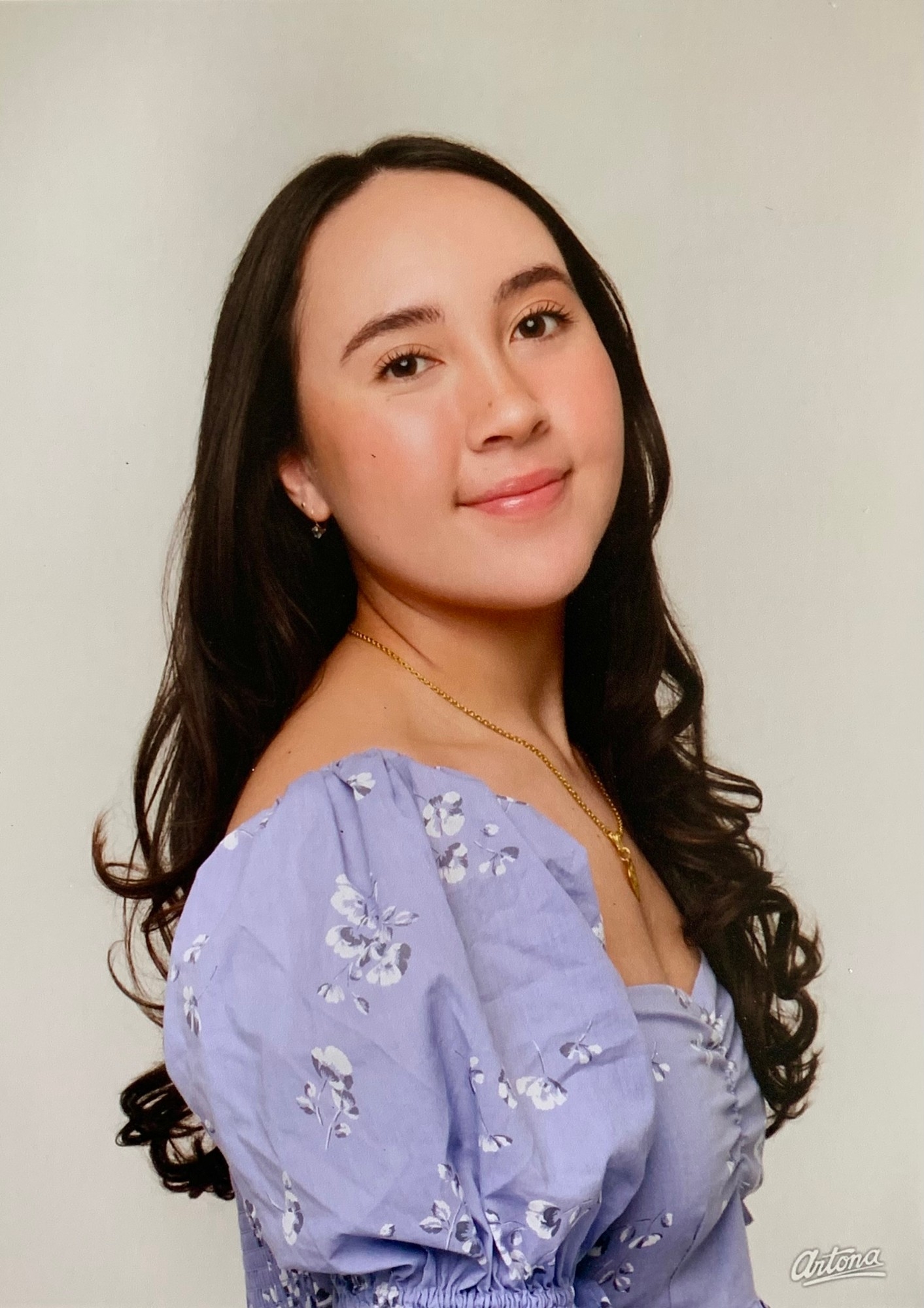 A headshot of SFU Publishing minor student Genevieve Cheng wearing a purple floral dress.