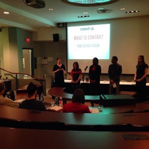 Students presenting in front of a projection screen