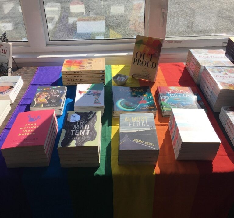 Table displaying stacks of titles published by Breakwater Books