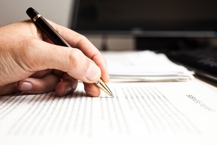 Person writing on a document