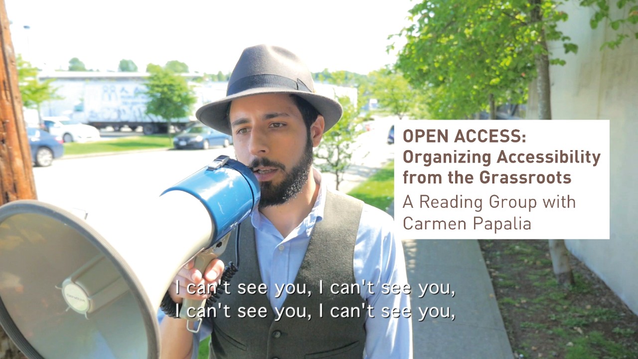 Carmen Papalia, White Cane, Amplified, 2015, video still (artwork © Carmen Papalia; photograph by Philip Lui). Image description: In this still from a video, a bearded man wearing a gray hat holds a megaphone to his face. He is walking along a suburban street on a bright sunny day. The caption in the video says, “I can’t see you, I can’t see you, I can’t see you, I can’t see you.”