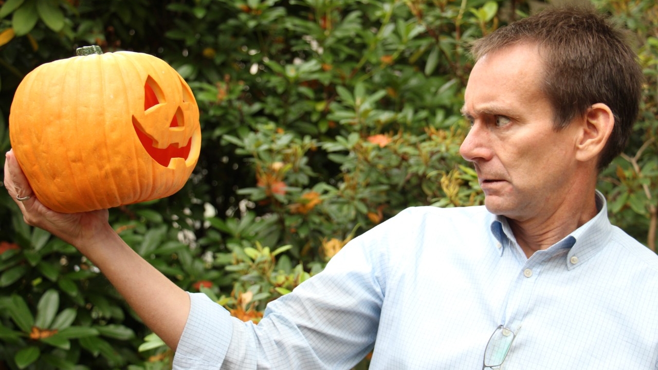Dr. Mike Hayden, holding a pumpkin