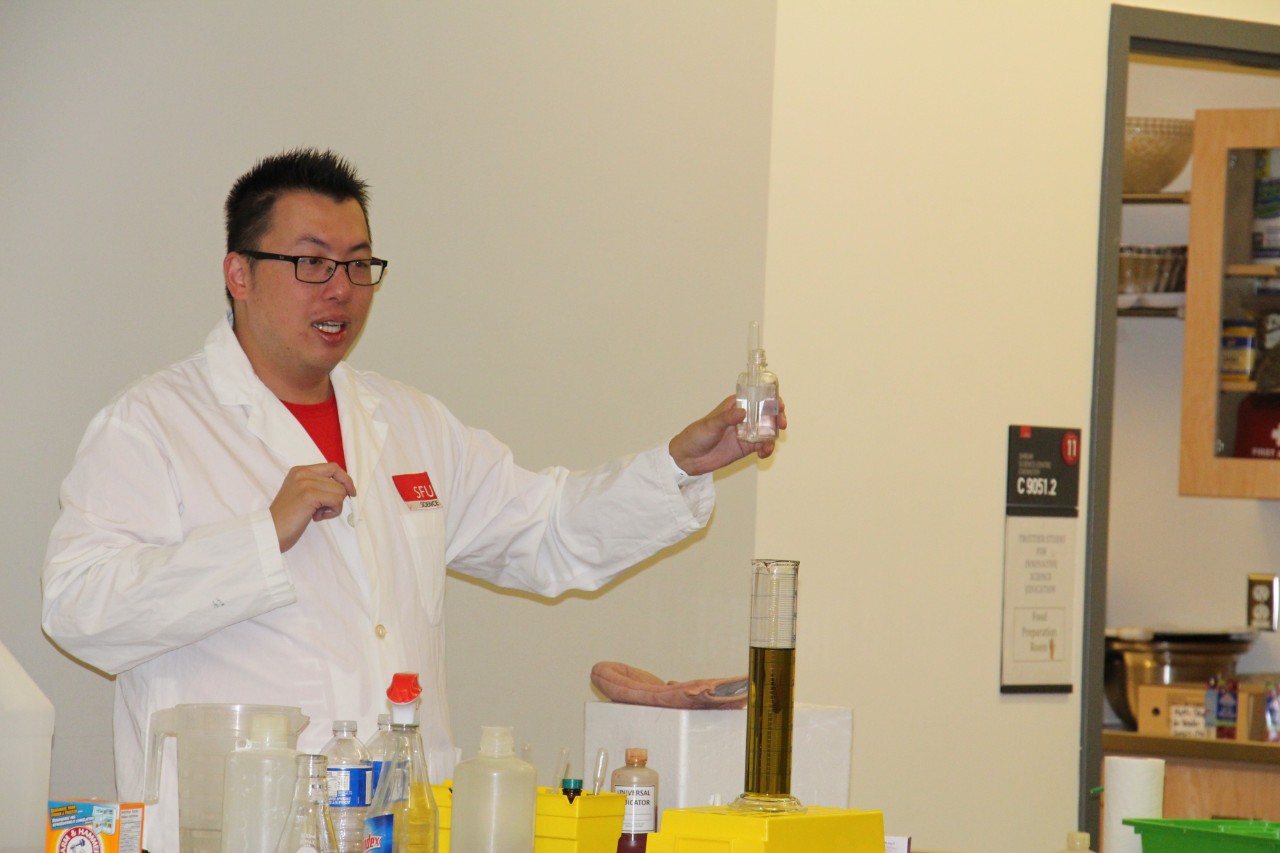 Chemistry, man in lab coat holding beaker