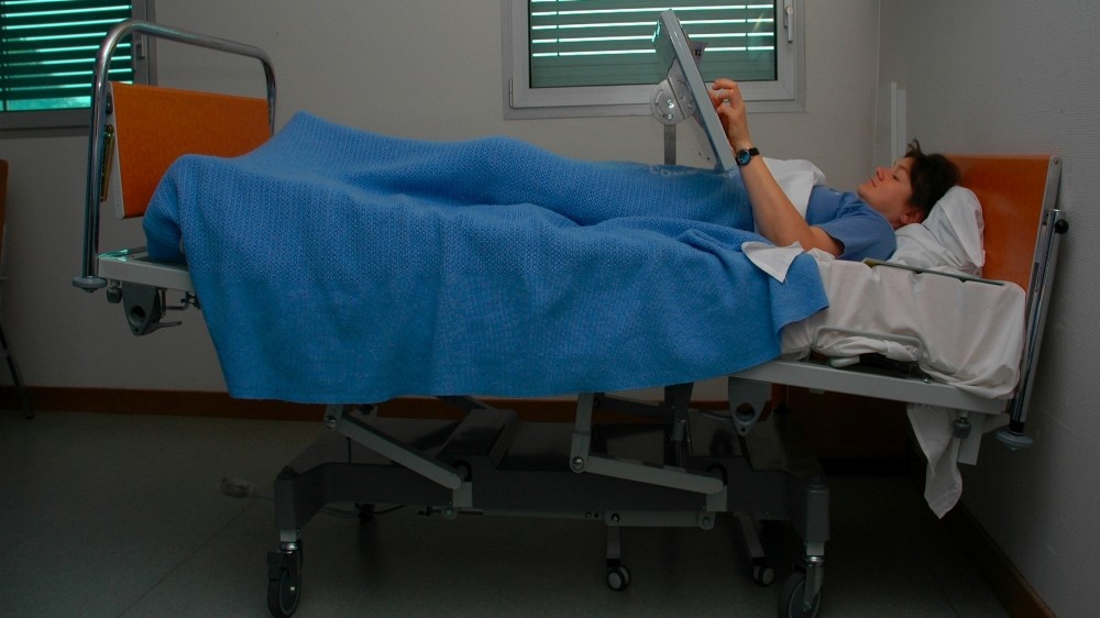 woman lying in hospital bed