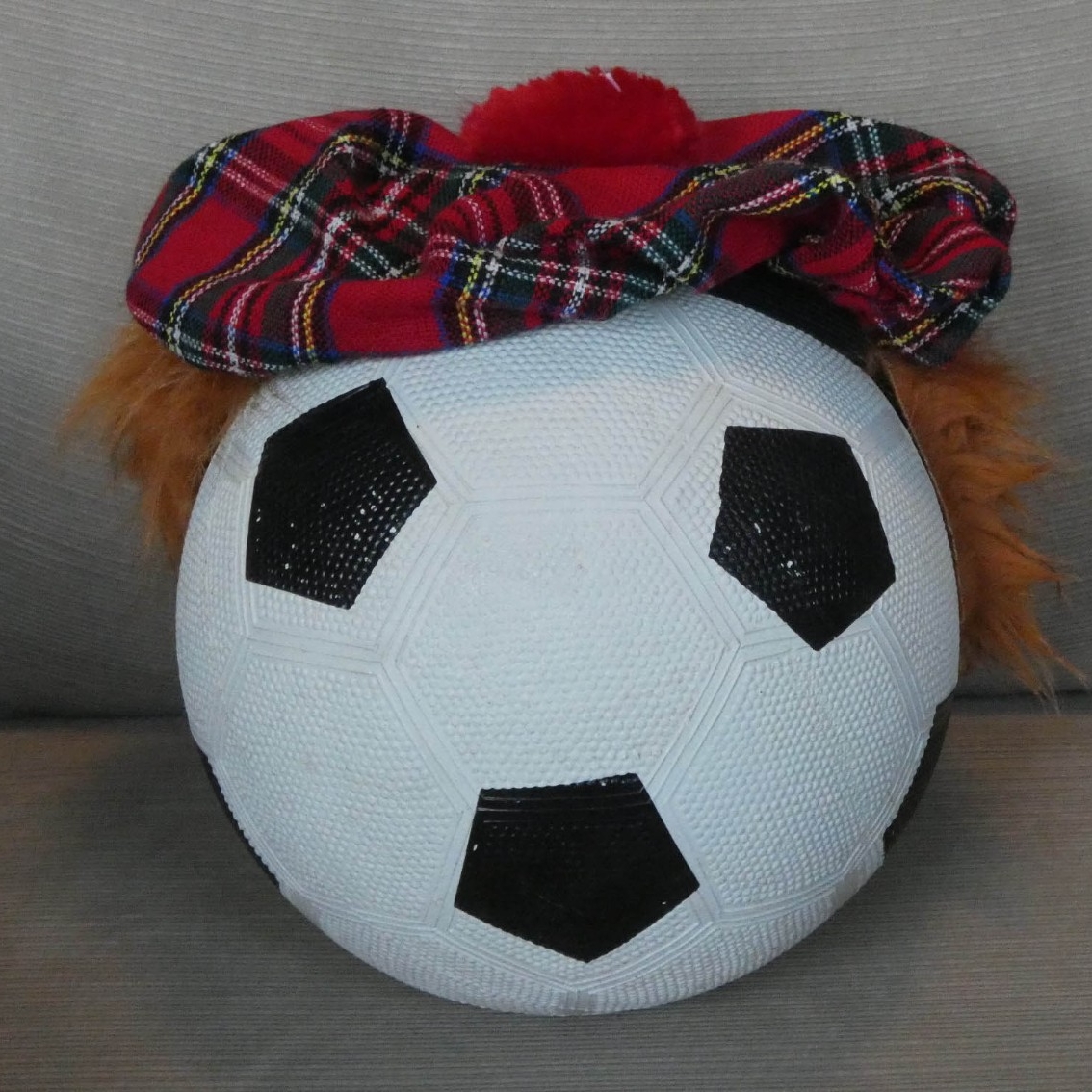 soccer strip of the Celtic Football Club, soccer ball with red-haired wig, and Scottish hat