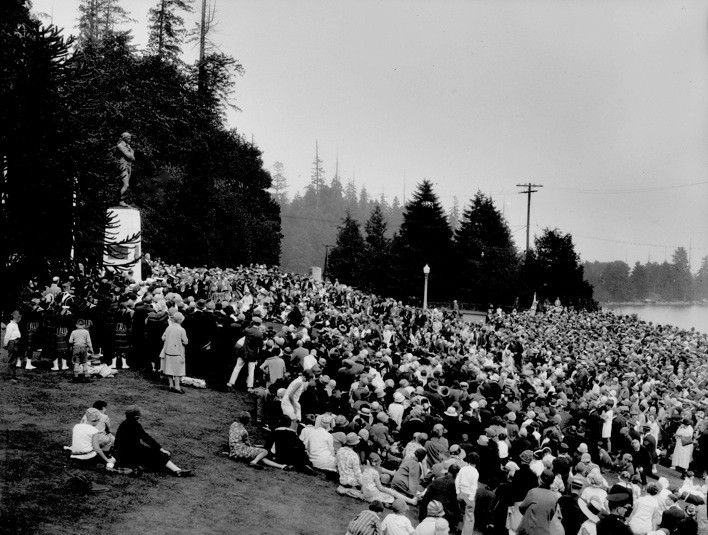 Black and white photo of Stanley Park with a crowd around the Robbie Burns statue