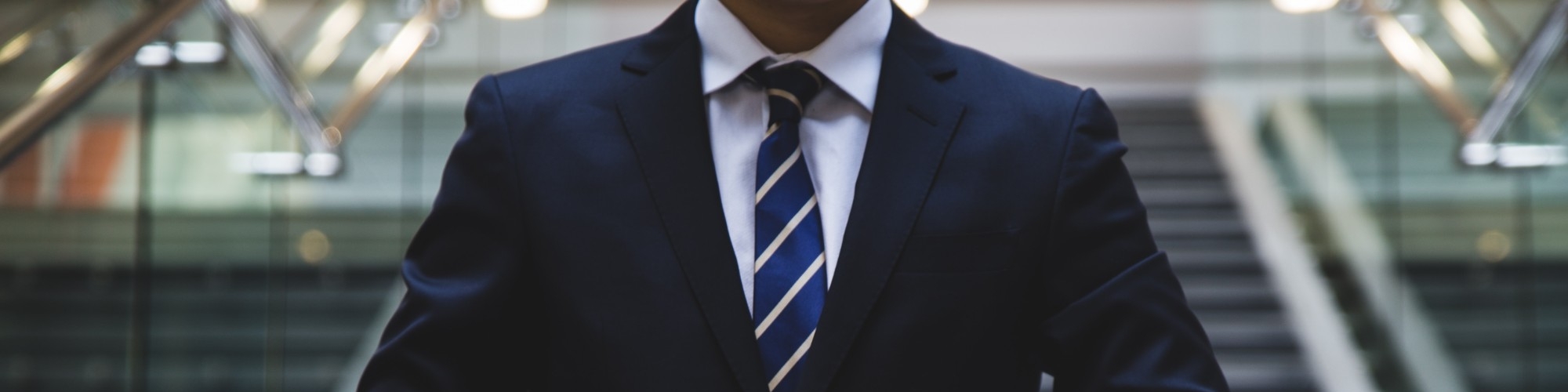 torso of a man wearing a suit and tie