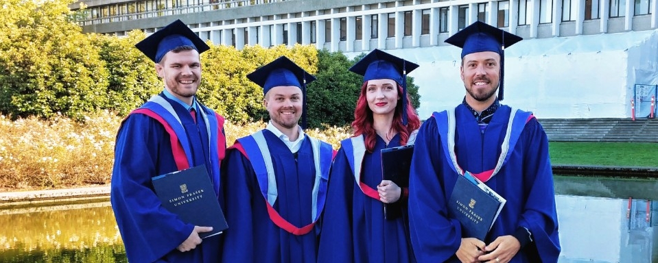 four SFU Urban Studies graduates wearing regalia
