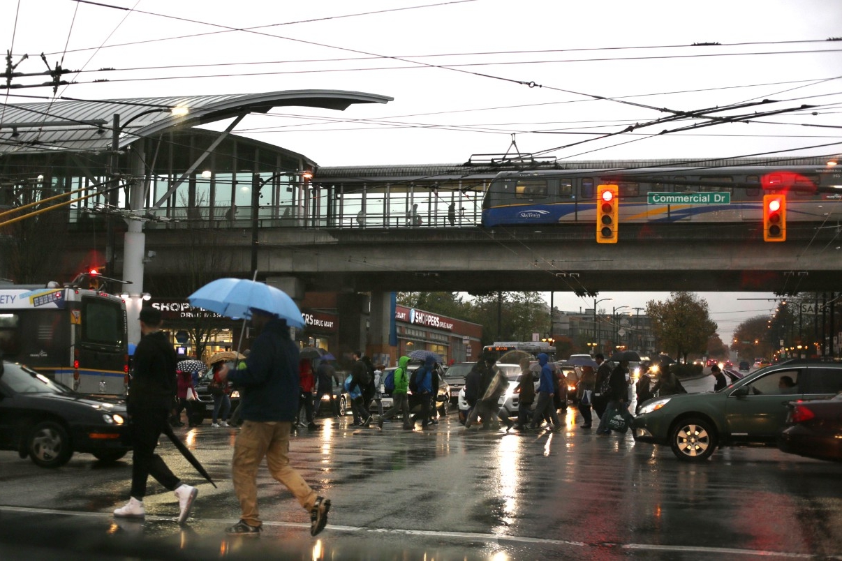 People crossing the street in East Vancouver in the rain