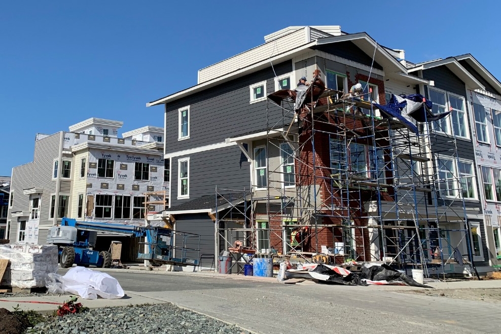 Langley townhomes under construction; header: Township of Langley Development Process Review