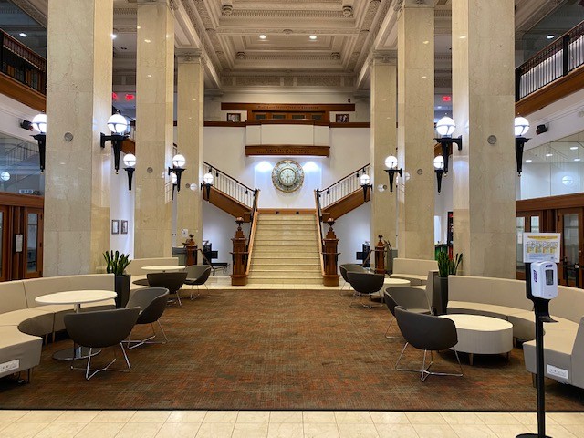 Large open lobby space with seating and a large staircase 