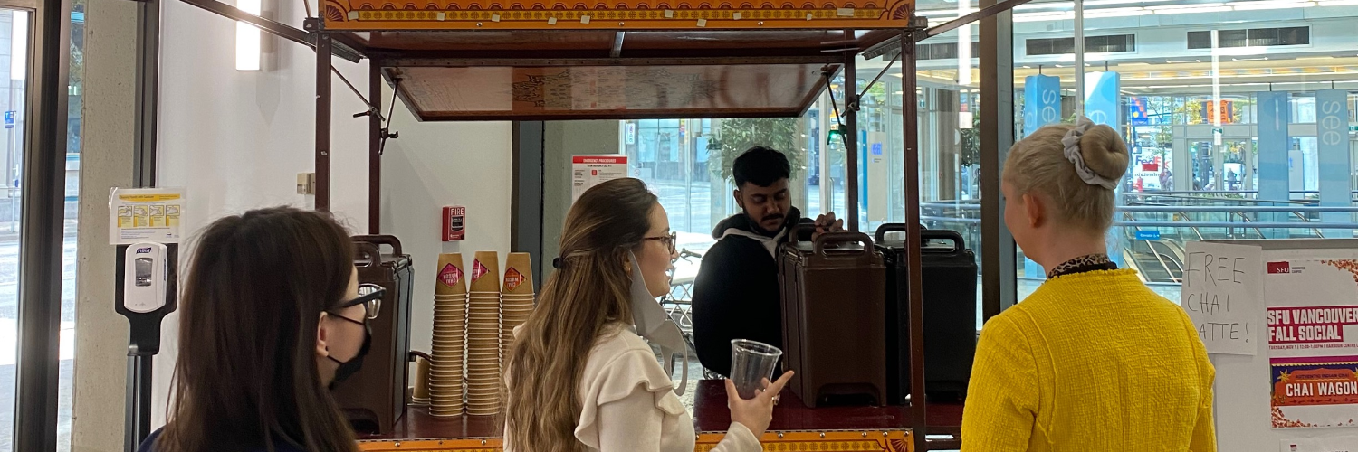 People waiting in line for chai lattes from the Chai Wagon at the 2022 Fall Social