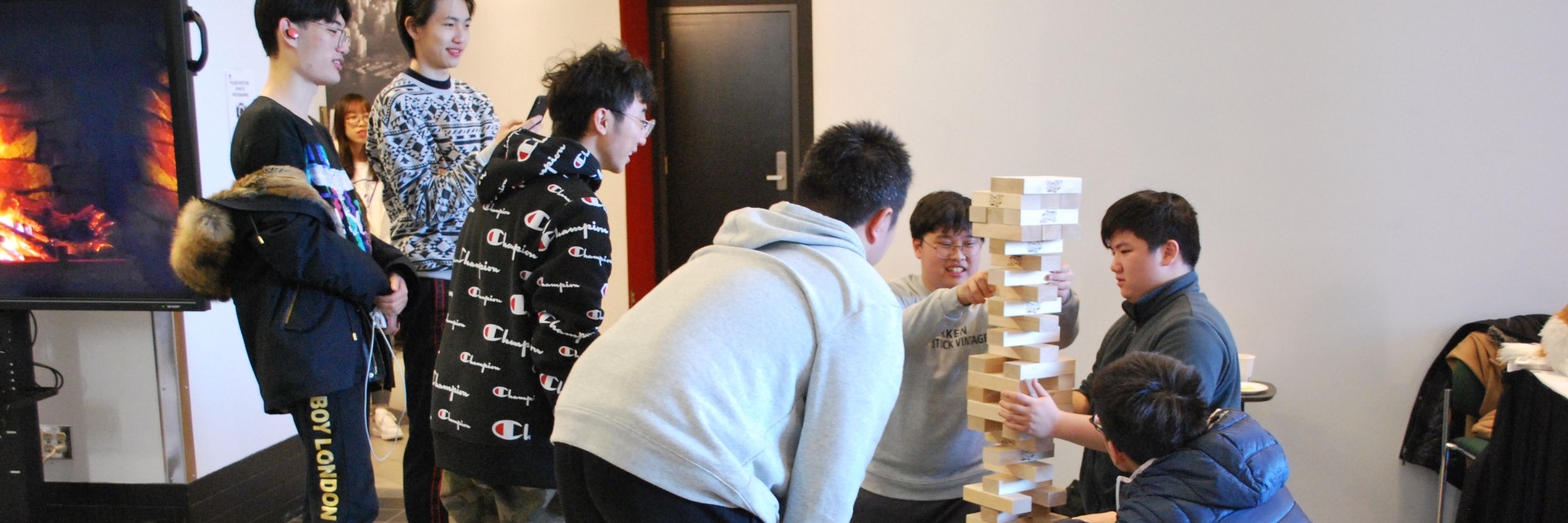 Group of students playing Giant Jenga in the Games Lounge