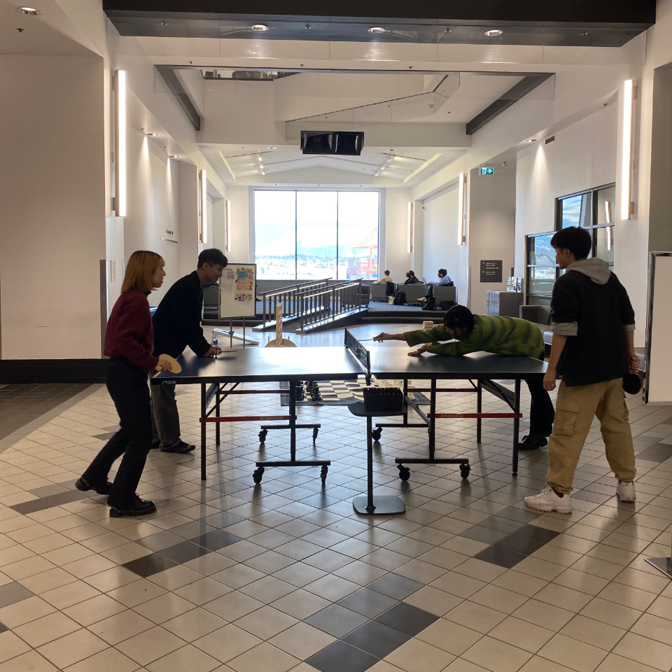 Four students playing Ping Pong in the Harbour Centre Concourse