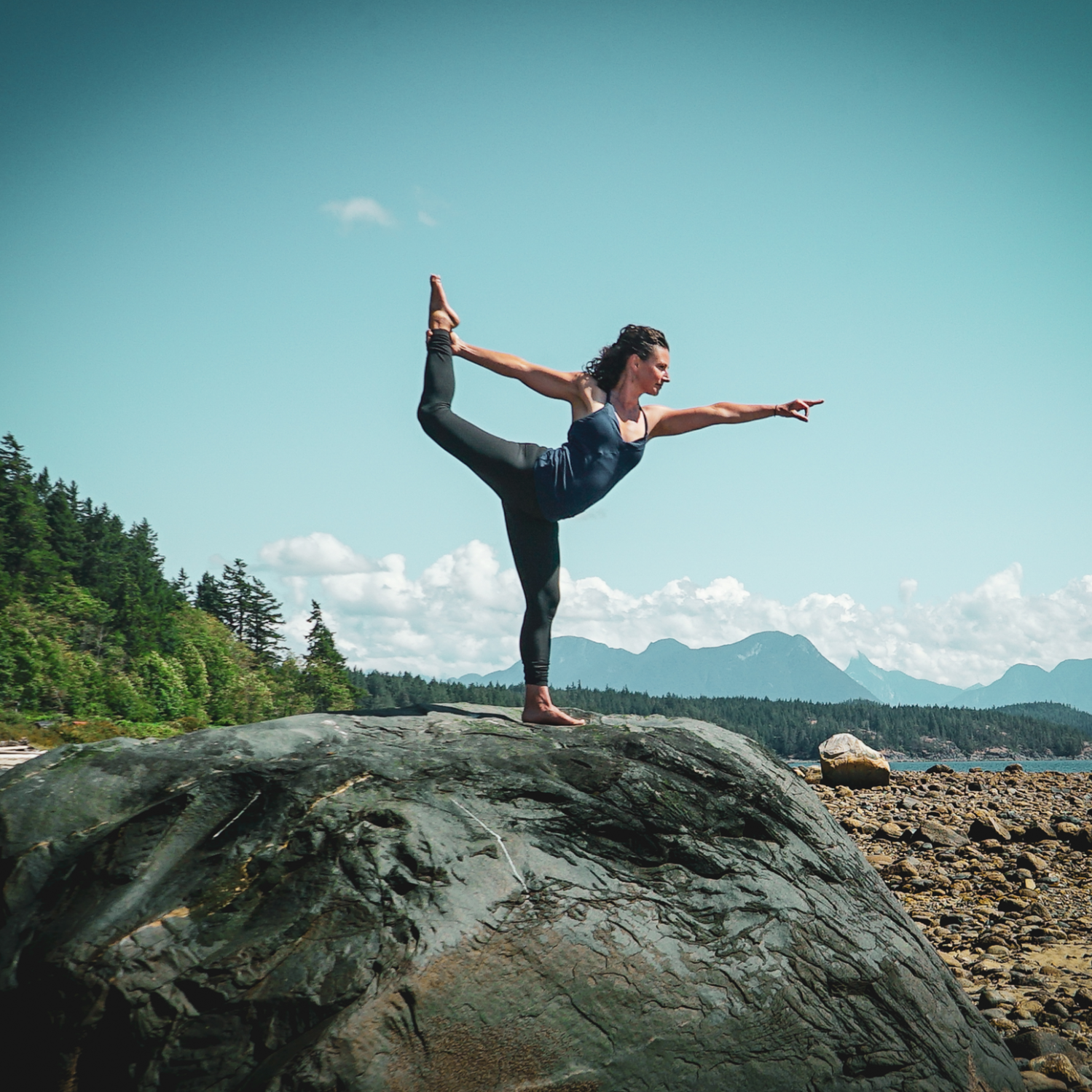 Yoga instructor, Fiji McAlpine, practicing a Yoga pose outdoors on a large rock