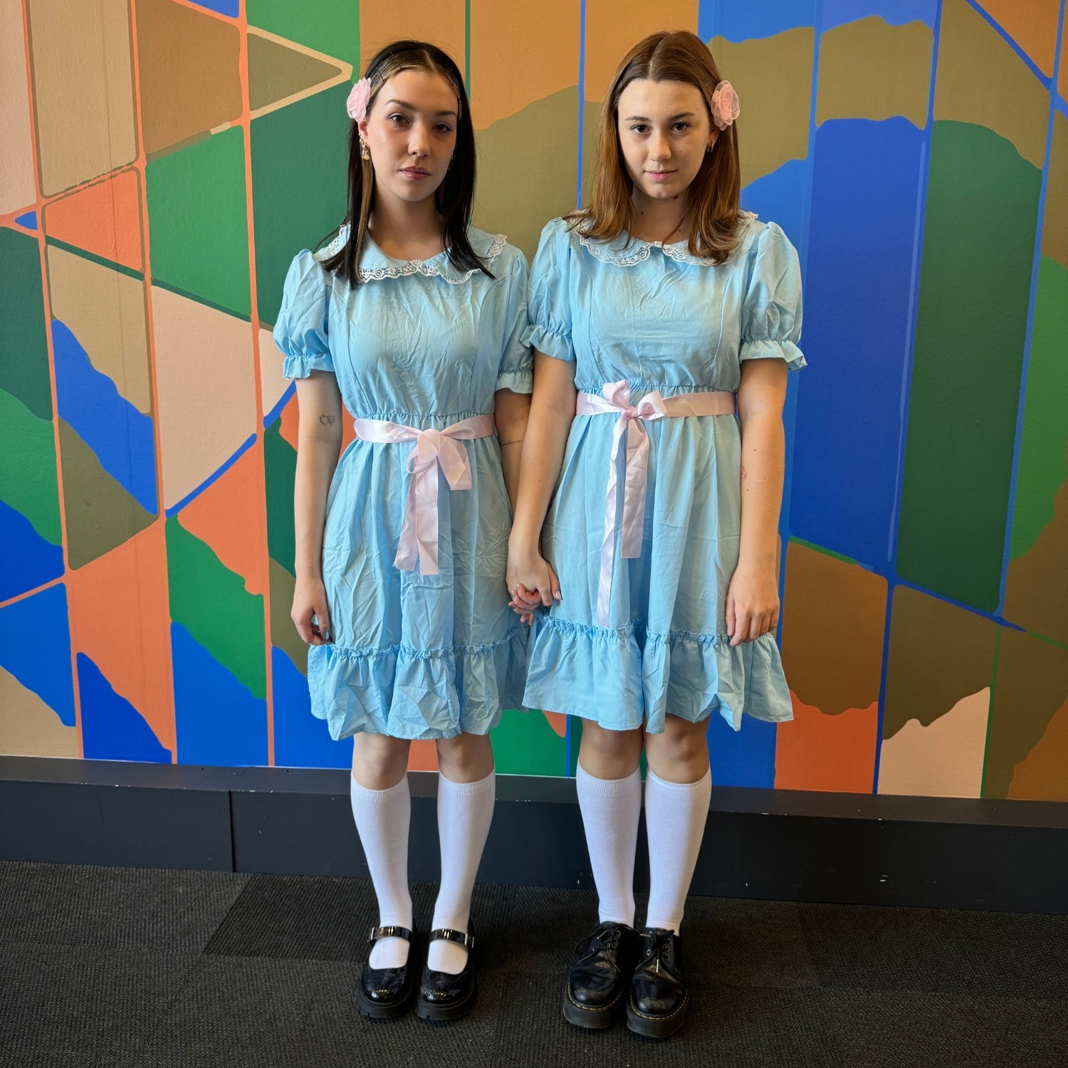 Two people dressed up as the twins from the movie, The Shining, at 2023 Halloween Social