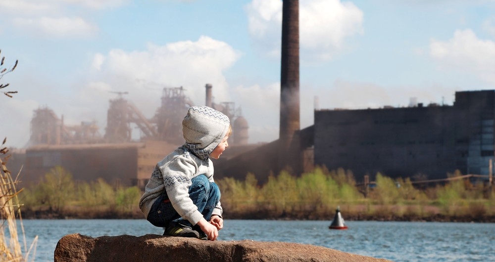 Industrial landscape with playing boy