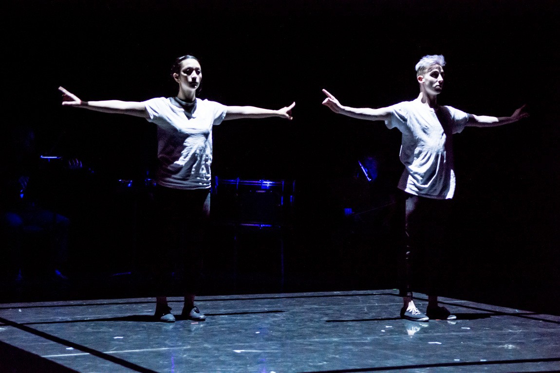 2 Dancers on stage with hands extended outwards taking up space