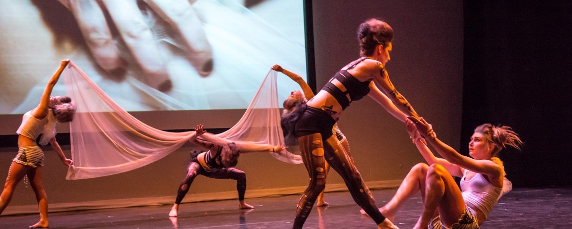 Subscrua performs Spiders vs. Moths at a preview of Liz Cairn's short film Withering Heights dancers on floor with fabric helping other dancers up 