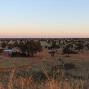 A sunset view of //Uruke Bush Camp Adventures. The land was returned to the +Kho