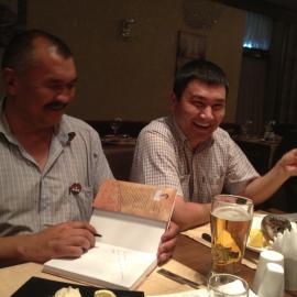 Kubat Tabaldiev signs his new book on Kyrgyz archaeology, and Chynarbek Joldosho
