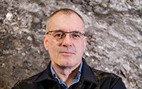 headshot of researcher Mark Collard