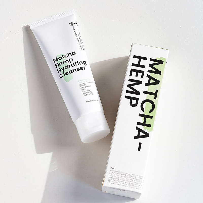 A tube of matcha cleanser and box on a white background