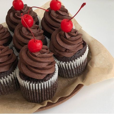 chocolate cupcakes with cherries on top